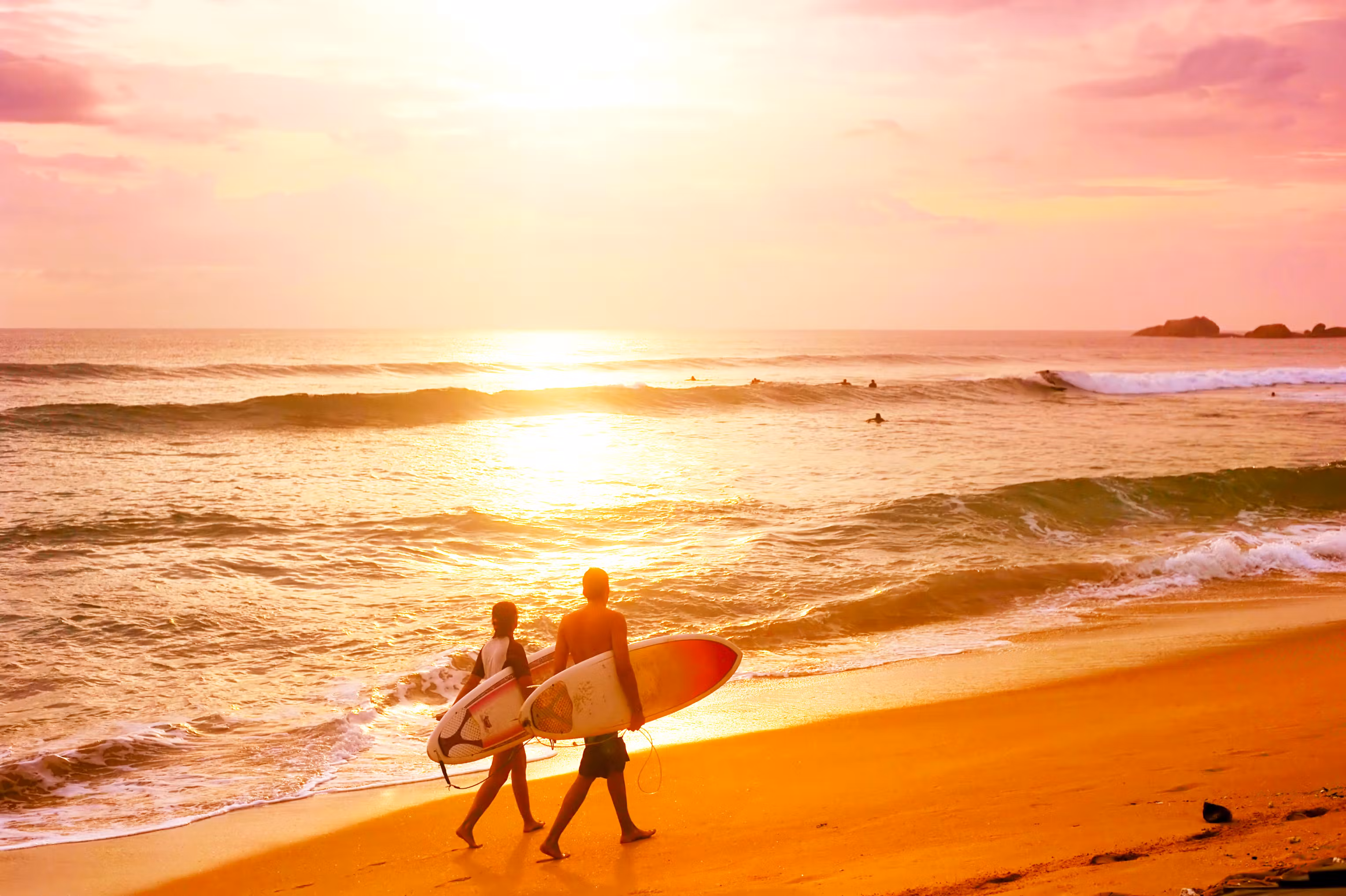 Surfers at sunset